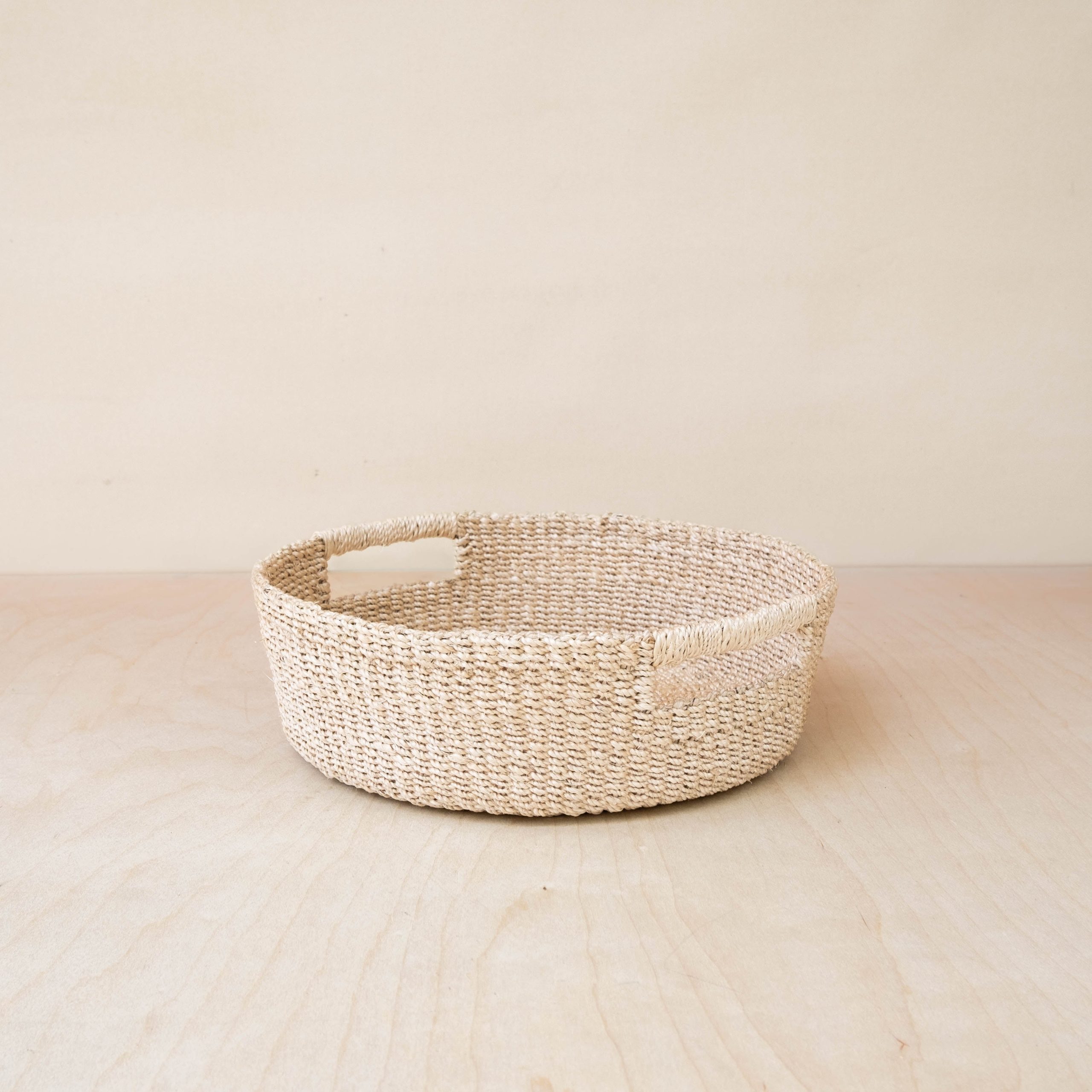 LIKHA_80117_Abaca-Round-Tray-with-Cutout-Handles-1.jpg